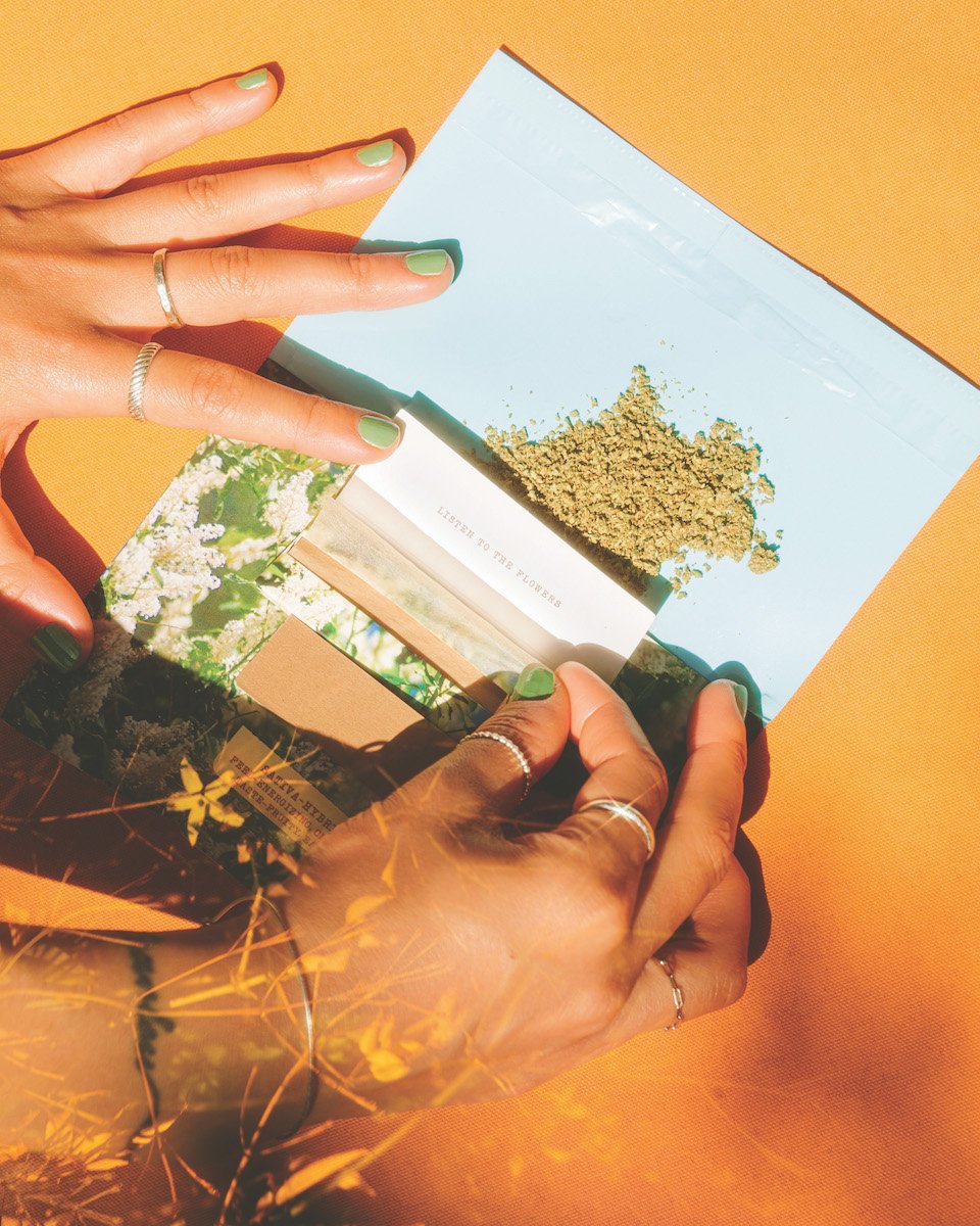 fingers-with-green-painted-nails-rolling-joint
