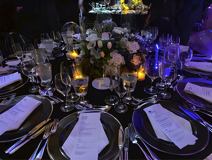 a close up shot of the table settings at the gala dinner