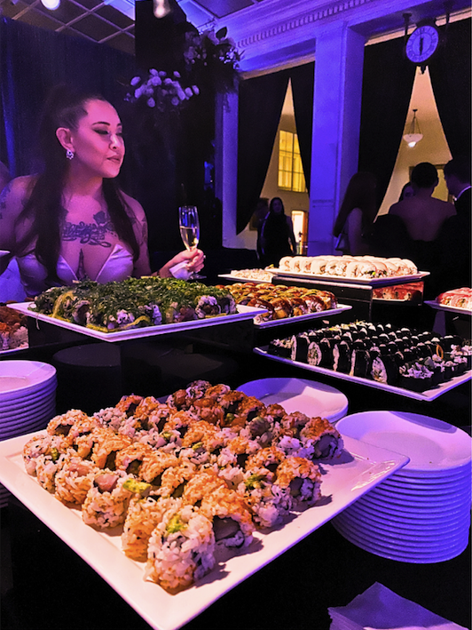 the author of the article looks over a spread of sushi