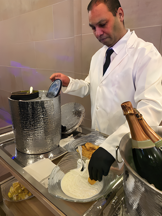 a server at the champagne and caviar station