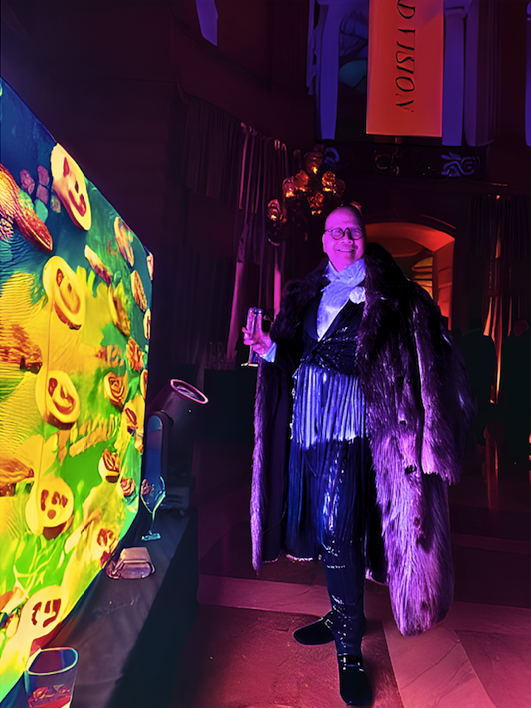 a queer man wearing a pinstriped tuxedo, Chanel lapel flower, and fur overcoat poses with a glass of champagne
