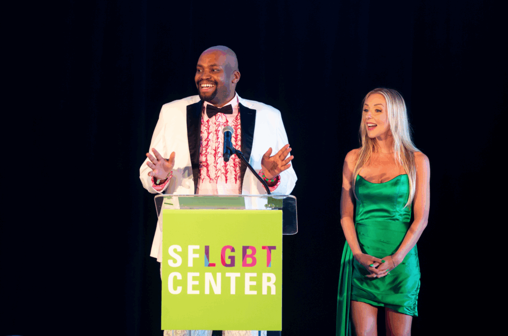 auctioneer Michael Tate speaking onstage at the podium