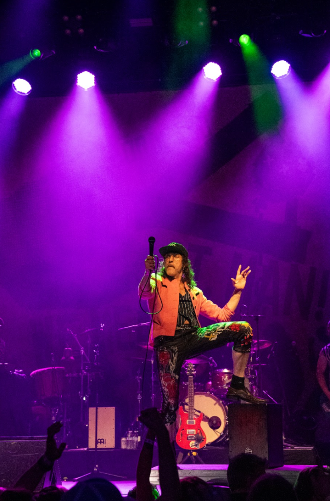 Gogol Bordello full band performing with backdrop banner at The Warfield