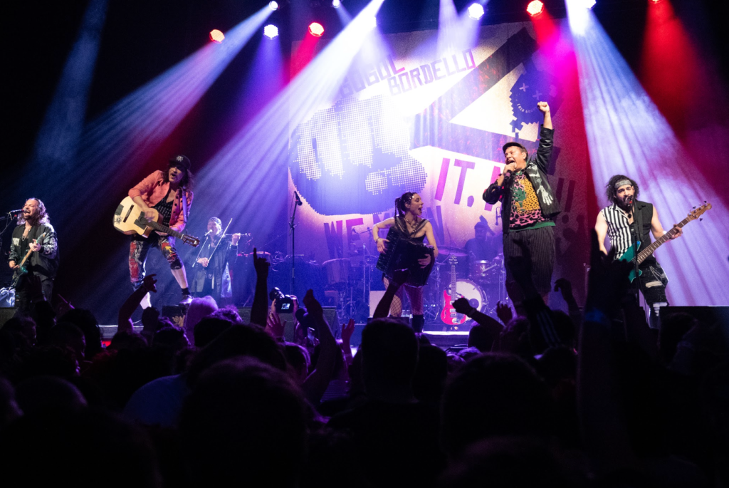 Two vocalists performing together at Gogol Bordello concert