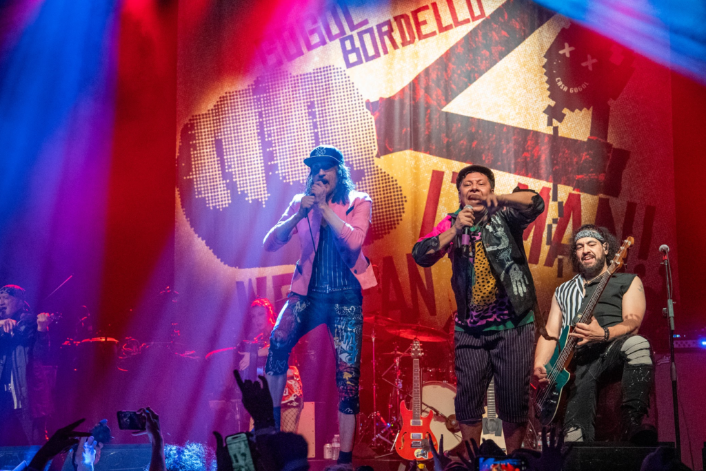 Eugene Hütz mid-kick during Gogol Bordello performance at The Warfield