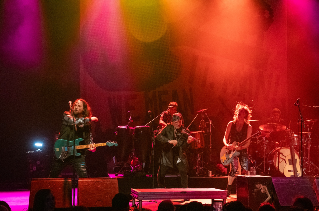 Eugene Hütz singing while bandmate plays synth during live performance
