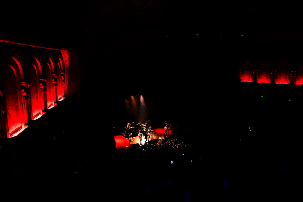 Wide shot of The Warfield with red balcony lighting during concert