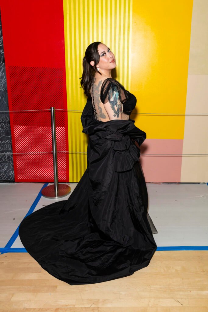 Guest in dramatic black gown posing at SFMOMA Art Bash