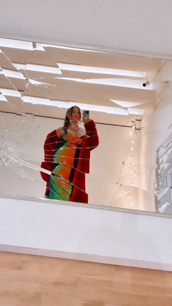 Guest taking mirror selfie in reflective art installation at SFMOMA