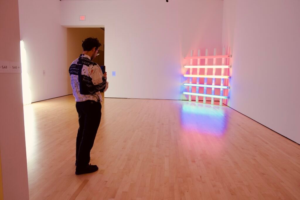 Guest photographing neon light installation at SFMOMA