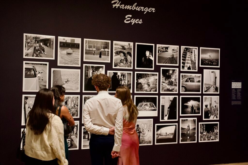 Guests viewing Hamburger Eyes photography exhibit at SFMOMA