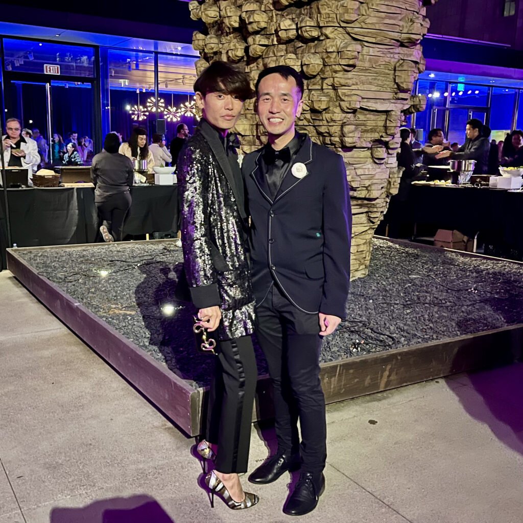 Guests in a black sequin jacket and tailored tuxedo at SFMOMA Art Bash