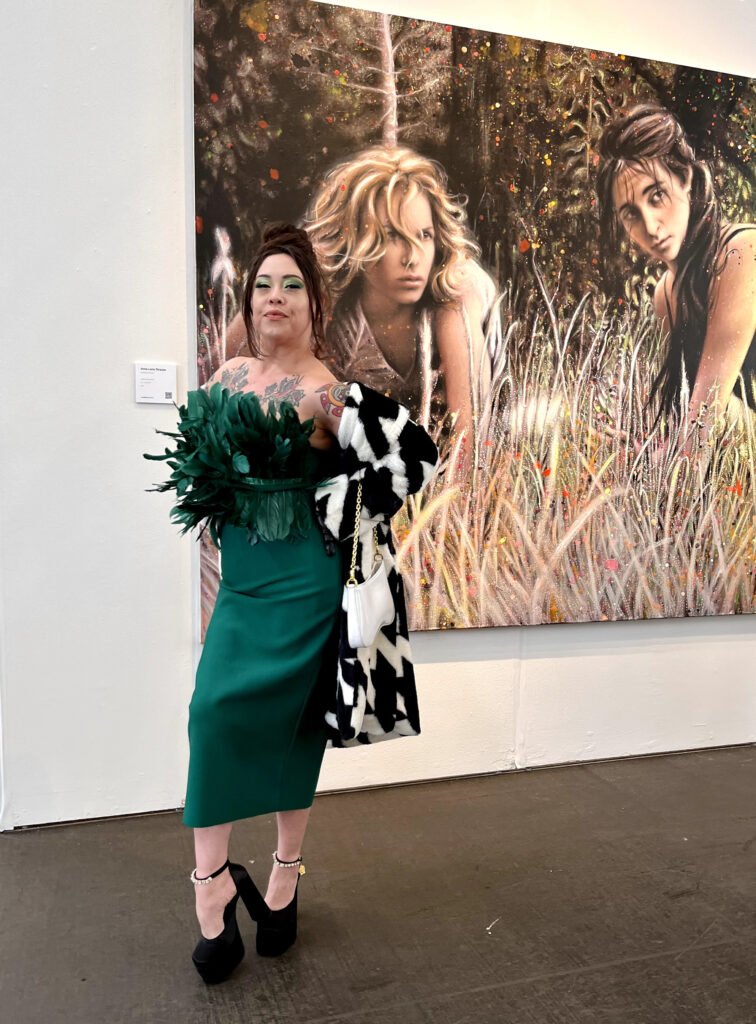 Guest in a green feather detail dress posing in front of artwork at SFMOMA