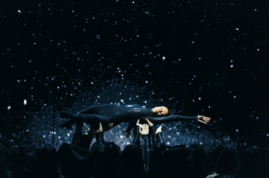 Nikisha Fogo lifted horizontally by ensemble dancers in Mere Mortals