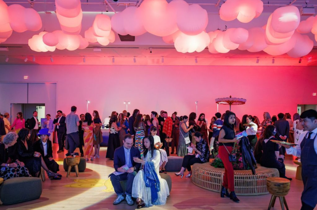 Crowd gathering at Art Bash 2026 at SFMOMA under colorful ceiling installation