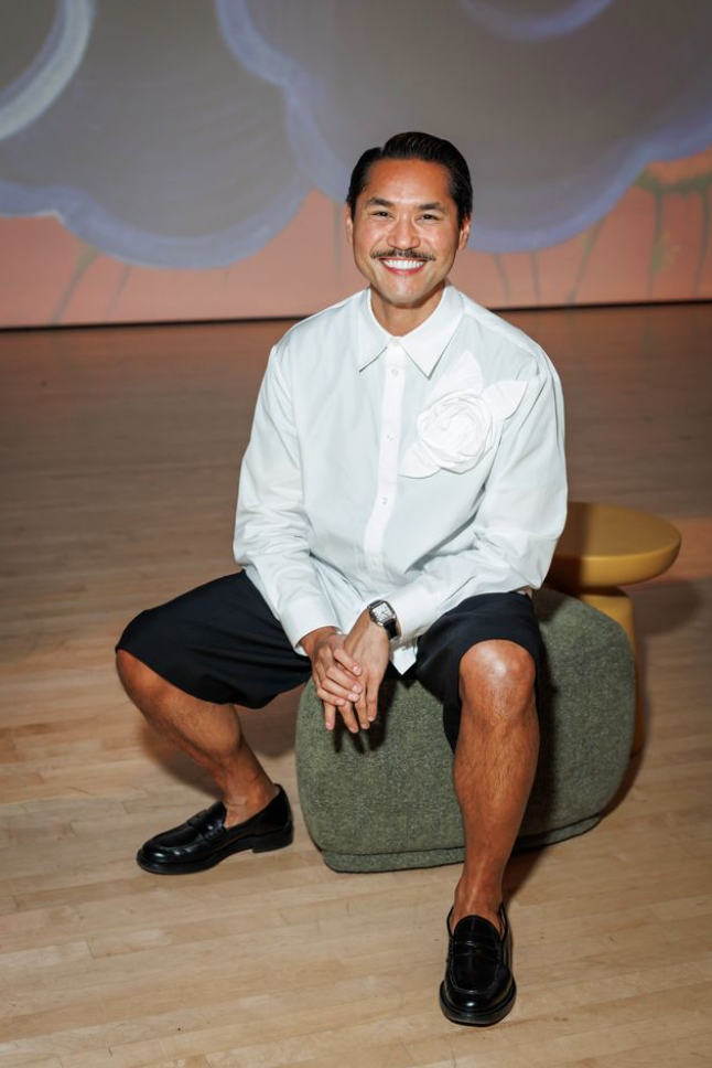 Guest seated at Art Bash 2026 at SFMOMA wearing white shirt and black shorts