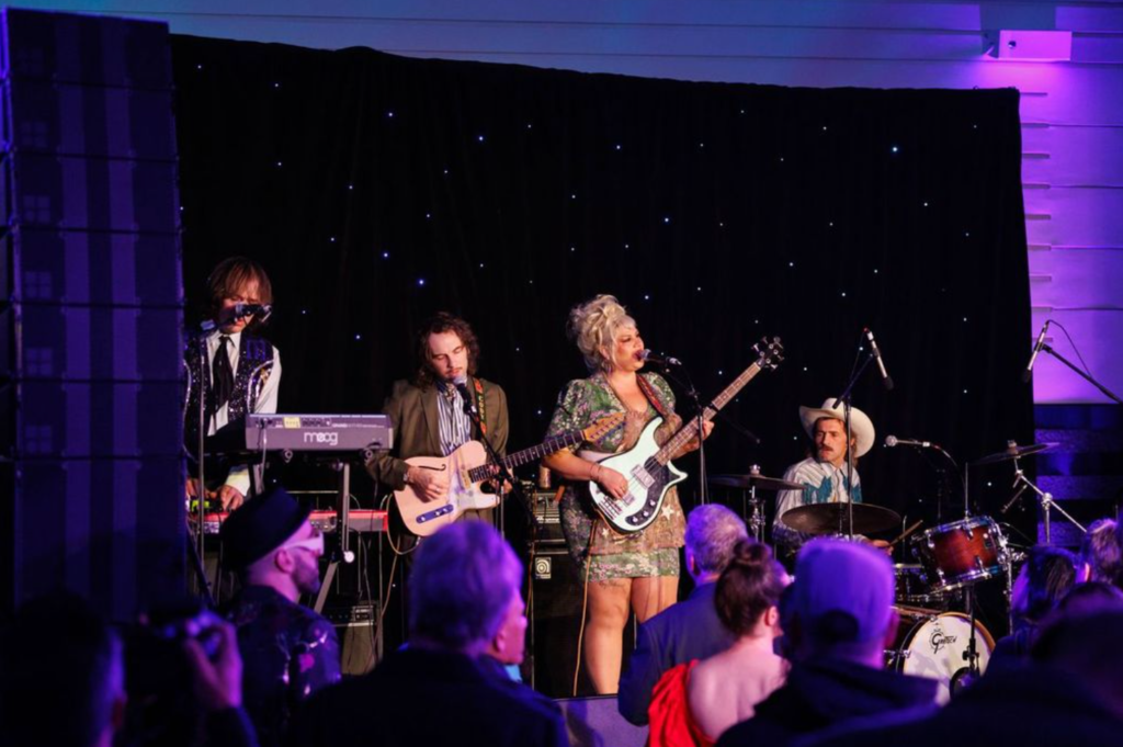 Live band performing on stage during Art Bash 2026 at SFMOMA with audience in foreground