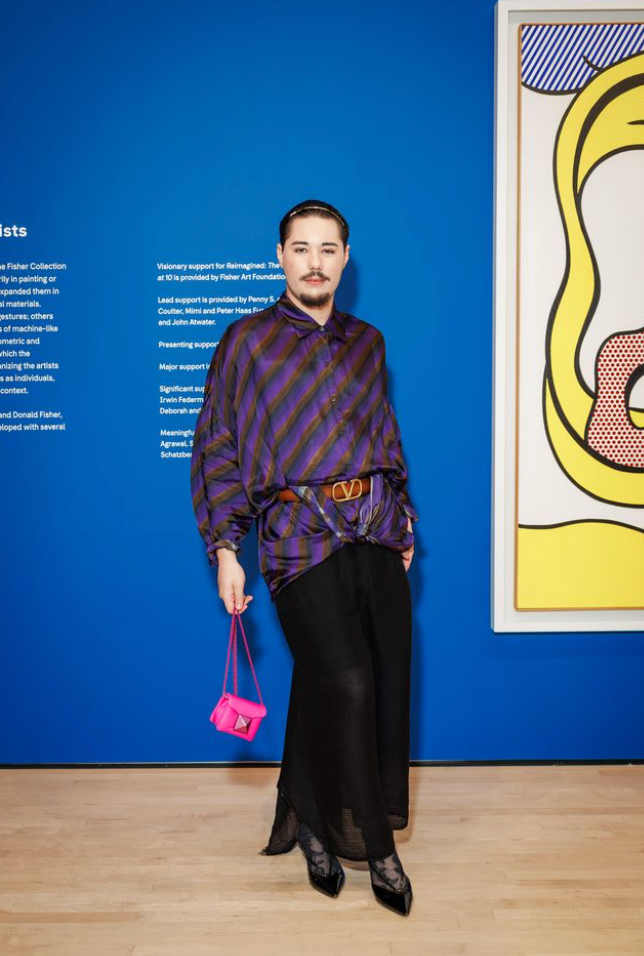 Guest posing inside SFMOMA gallery at Art Bash 2026 with modern artwork in background